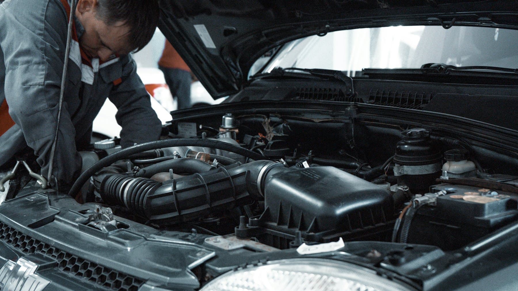 Mechanic working under a car bonnet