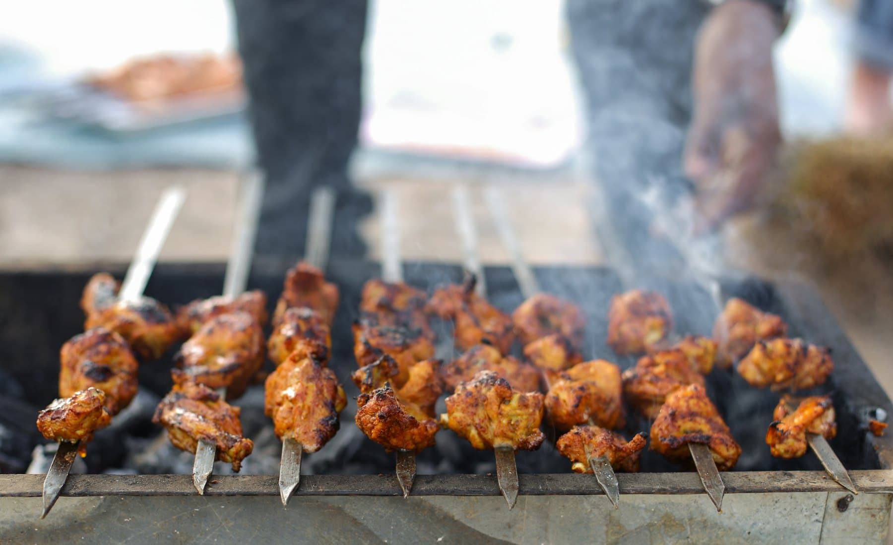 Kebabs cooking over a charcoal grill